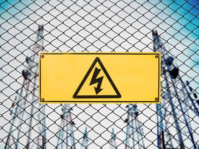 High Voltage Sign and Symbol Caution Signboard on Fence Wire at Electrical Power Plant Station